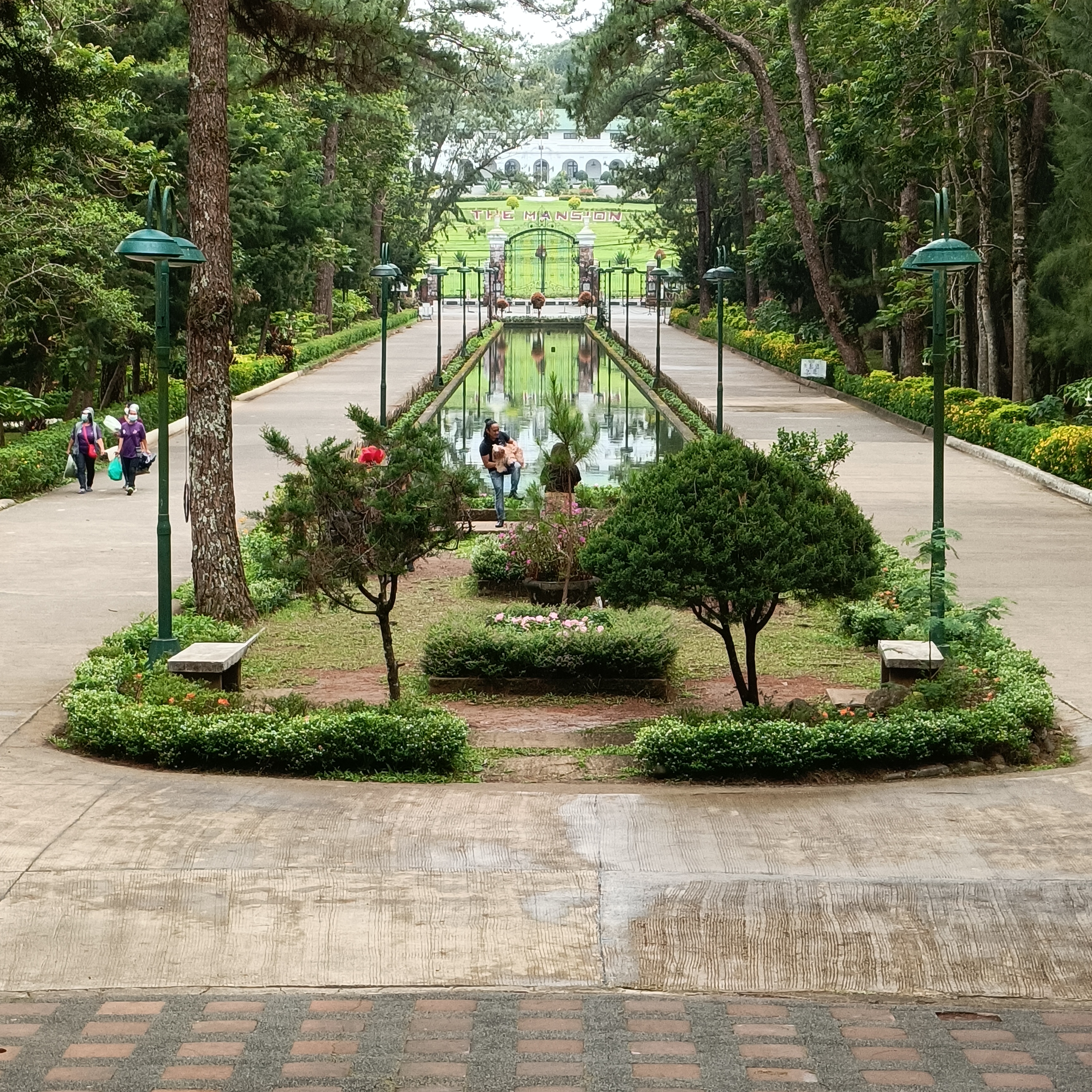 Panagbenga Flower Festival grand float parade at Burnham Park Baguio — colorful flowers, crowd, and pine trees